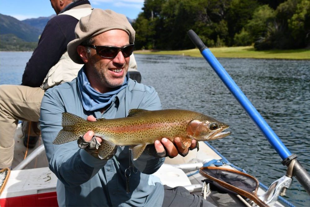 Angler with a trout on a Patagonian river